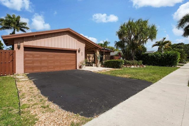 650 NW 48th Ave, Coconut Creek, FL 33063 - ranch-style house featuring a garage, a front lawn, and driveway