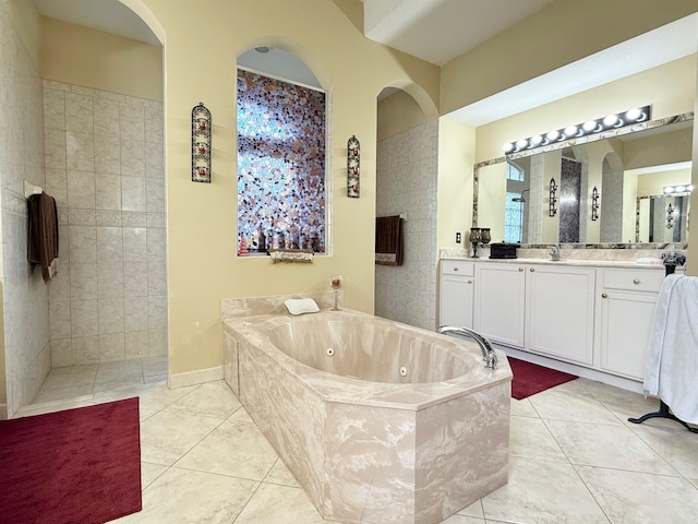 bathroom with walk in shower, a tub with jets, tile patterned flooring, and vanity