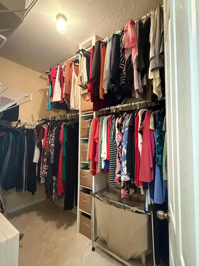 walk in closet with tile patterned flooring