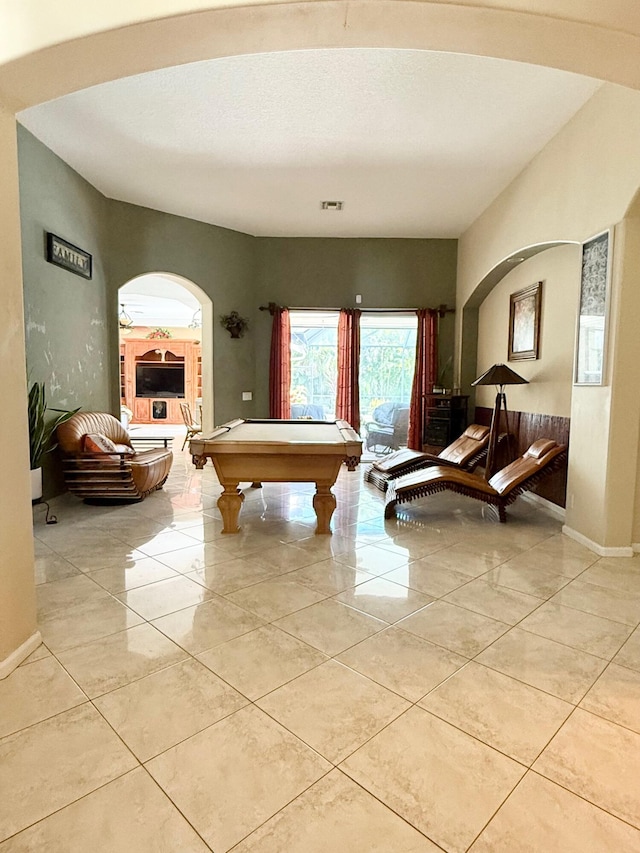playroom featuring tile patterned floors, visible vents, baseboards, arched walkways, and pool table
