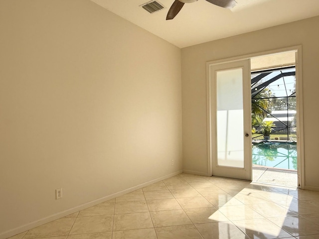 spare room with light tile patterned floors, visible vents, baseboards, and a ceiling fan