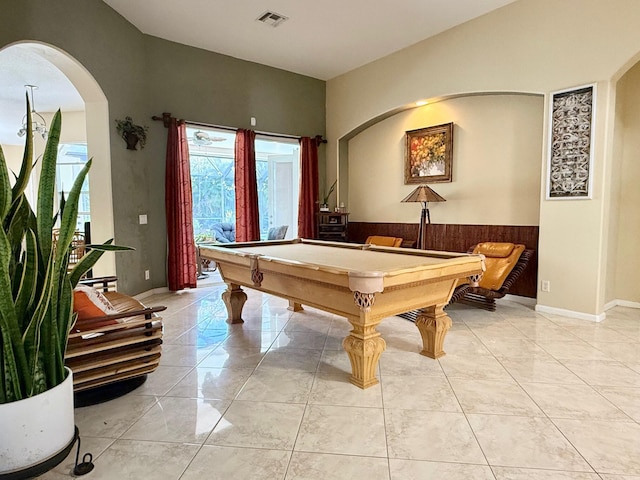 rec room with a wainscoted wall, marble finish floor, visible vents, arched walkways, and billiards