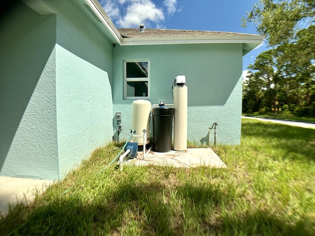 view of home's exterior featuring a yard and stucco siding