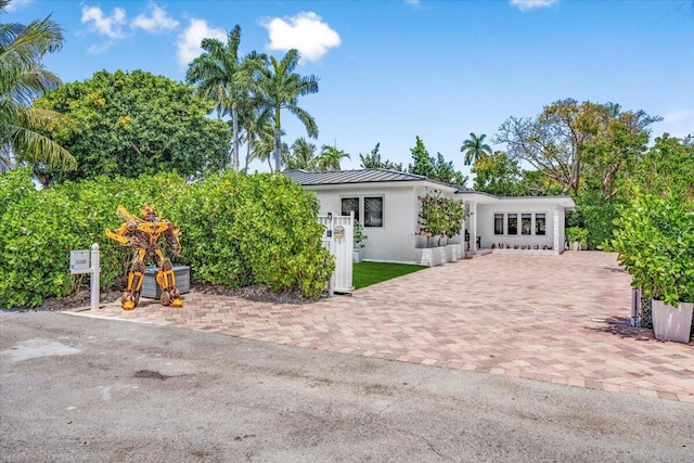 6100 La Gorce Dr, Miami Beach, FL 33140 - rear view of property with a standing seam roof, stucco siding, and metal roof