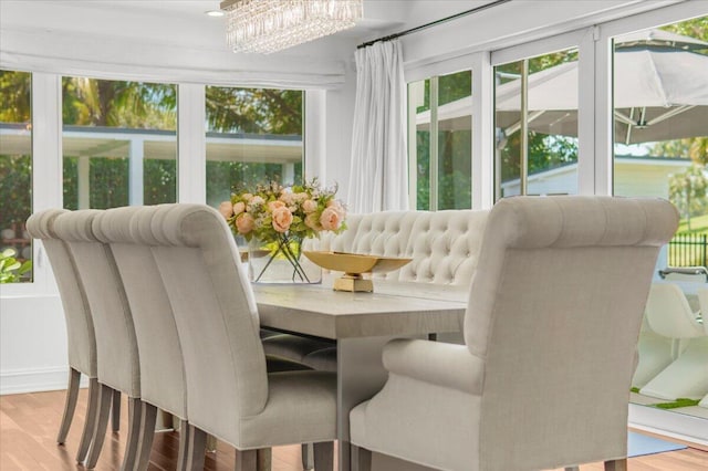 6100 La Gorce Dr, Miami Beach, FL 33140 - dining area with wood finished floors and plenty of natural light