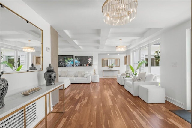 living room featuring coffered ceiling, baseboards, an inviting chandelier, wood finished floors, and beamed ceiling