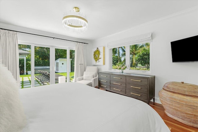 6100 La Gorce Dr, Miami Beach, FL 33140 - bedroom with access to outside, wood finished floors, ornamental molding, and a chandelier