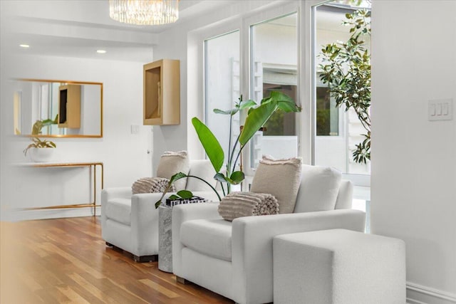 6100 La Gorce Dr, Miami Beach, FL 33140 - sitting room featuring wood finished floors, a chandelier, and baseboards
