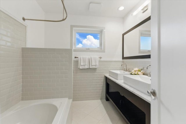 6100 La Gorce Dr, Miami Beach, FL 33140 - full bathroom with tile patterned floors, tile walls, double vanity, healthy amount of natural light, and tub / shower combination