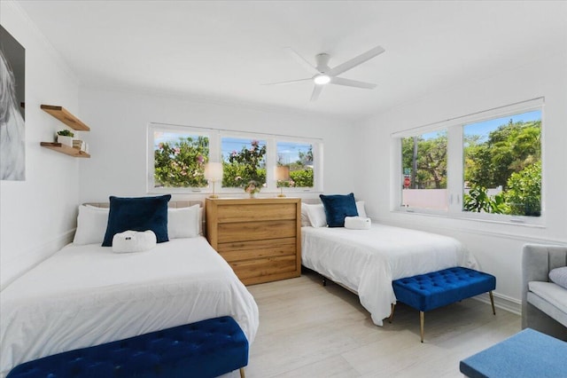 6100 La Gorce Dr, Miami Beach, FL 33140 - bedroom featuring multiple windows, light wood finished floors, and ceiling fan