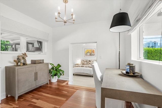 6100 La Gorce Dr, Miami Beach, FL 33140 - dining space featuring a chandelier and wood finished floors