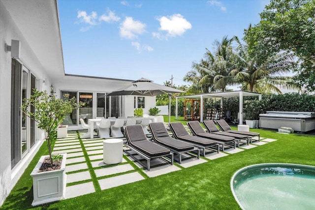 exterior space featuring a hot tub, a patio area, and a lawn