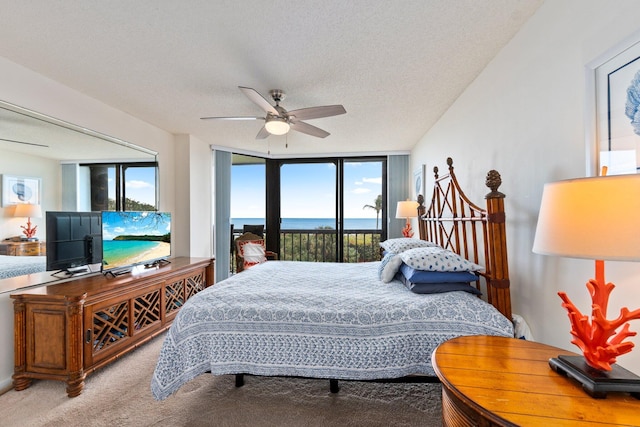 bedroom featuring carpet flooring, a textured ceiling, access to outside, and ceiling fan
