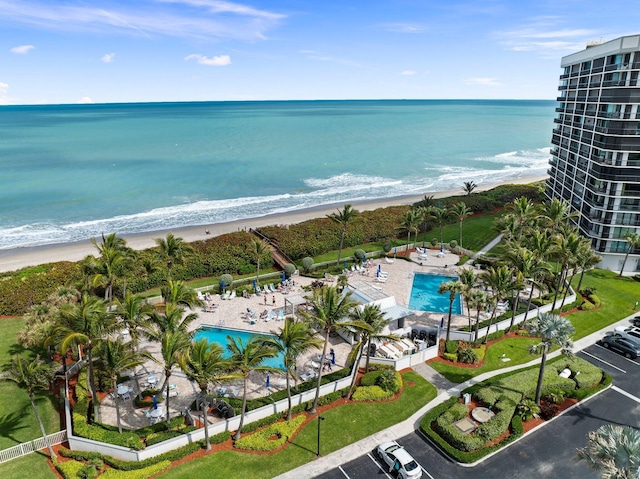 birds eye view of property with a view of the beach and a water view