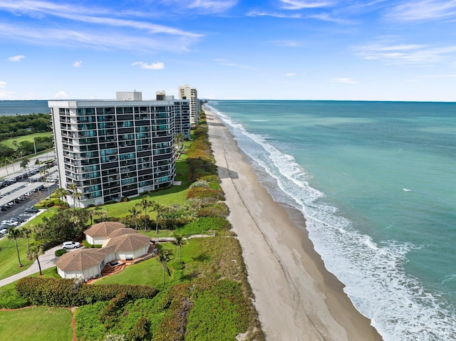 drone / aerial view featuring a water view and a view of the beach