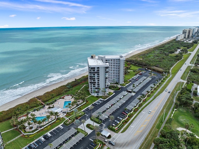 birds eye view of property with a view of the beach and a water view