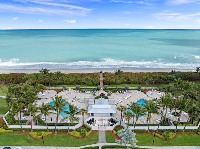 birds eye view of property featuring a view of the beach and a water view