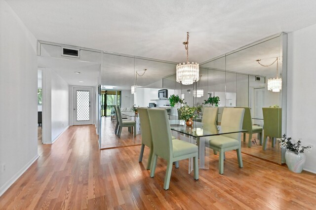 15244 Lakes Of Delray Blvd Unit 203, Delray Beach, FL 33484 - dining room with a chandelier, wood finished floors, and baseboards