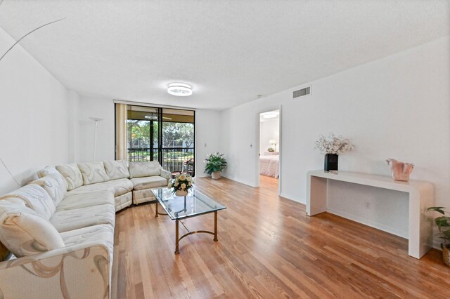 15244 Lakes Of Delray Blvd Unit 203, Delray Beach, FL 33484 - living room featuring wood finished floors and baseboards
