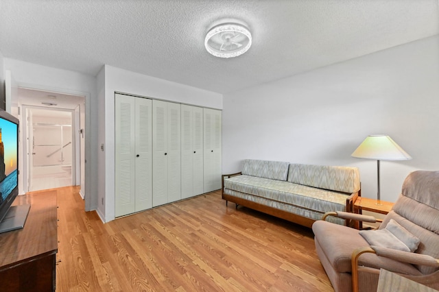 15244 Lakes Of Delray Blvd Unit 203, Delray Beach, FL 33484 - living area with light wood-type flooring and a textured ceiling