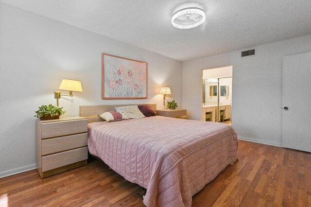 15244 Lakes Of Delray Blvd Unit 203, Delray Beach, FL 33484 - bedroom featuring wood finished floors, baseboards, and connected bathroom