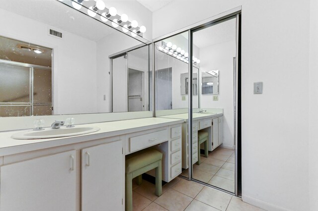 15244 Lakes Of Delray Blvd Unit 203, Delray Beach, FL 33484 - full bathroom featuring vanity, tile patterned floors, and an enclosed shower