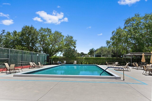 15244 Lakes Of Delray Blvd Unit 203, Delray Beach, FL 33484 - community pool with a patio and fence
