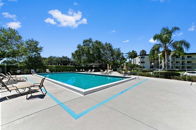 15244 Lakes Of Delray Blvd Unit 203, Delray Beach, FL 33484 - community pool featuring a patio area and fence