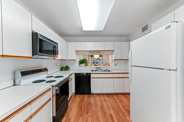 15244 Lakes Of Delray Blvd Unit 203, Delray Beach, FL 33484 - kitchen with freestanding refrigerator, electric range oven, black dishwasher, light countertops, and a sink