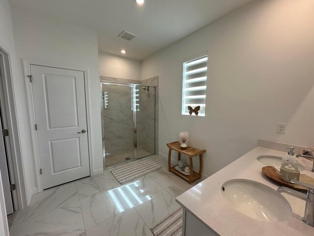 10230 SW Orana Dr, Port Saint Lucie, FL 34987 - bathroom featuring a shower stall, recessed lighting, double vanity, and marble finish flooring