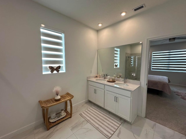10230 SW Orana Dr, Port Saint Lucie, FL 34987 - ensuite bathroom featuring marble finish floors, a shower stall, baseboards, double vanity, and recessed lighting