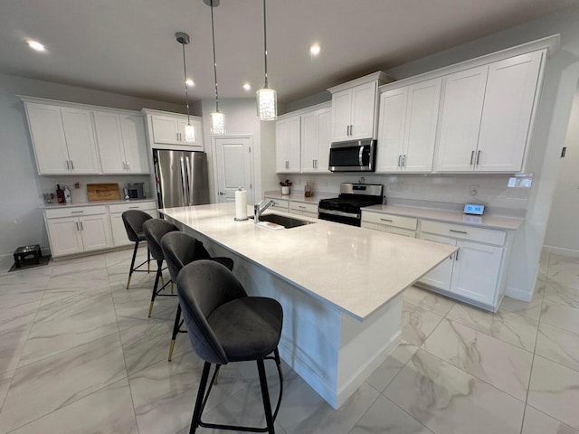 10230 SW Orana Dr, Port Saint Lucie, FL 34987 - kitchen with appliances with stainless steel finishes, light marble finish floors, a sink, recessed lighting, and a breakfast bar area