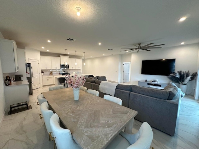 10230 SW Orana Dr, Port Saint Lucie, FL 34987 - dining space with ceiling fan, recessed lighting, and light marble finish flooring