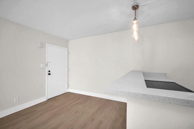 5821 Washington St Unit 21, Hollywood, FL 33023 - unfurnished dining area featuring wood finished floors and baseboards
