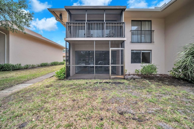5821 Washington St Unit 21, Hollywood, FL 33023 - rear view of property featuring stucco siding, a lawn, a sunroom, and a balcony