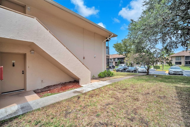 5821 Washington St Unit 21, Hollywood, FL 33023 - view of home's exterior featuring stucco siding, a yard, and a residential view