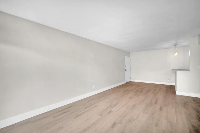 5821 Washington St Unit 21, Hollywood, FL 33023 - unfurnished living room with baseboards and wood finished floors