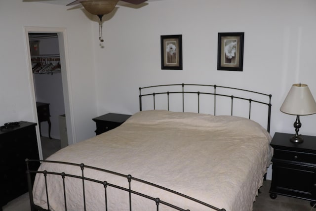 carpeted bedroom featuring a closet and a walk in closet