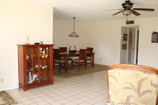 interior space with light carpet, visible vents, ceiling fan, and a textured ceiling