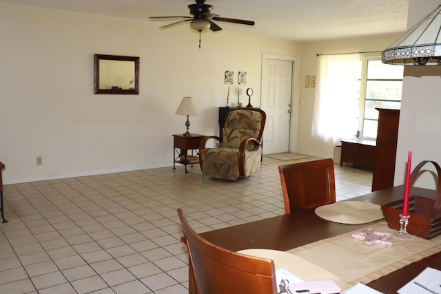 dining room featuring baseboards, ceiling fan, and light tile patterned flooring