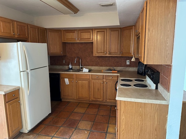 615 Garnett St, Lantana, FL 33462 - kitchen featuring freestanding refrigerator, a sink, backsplash, and brown cabinets