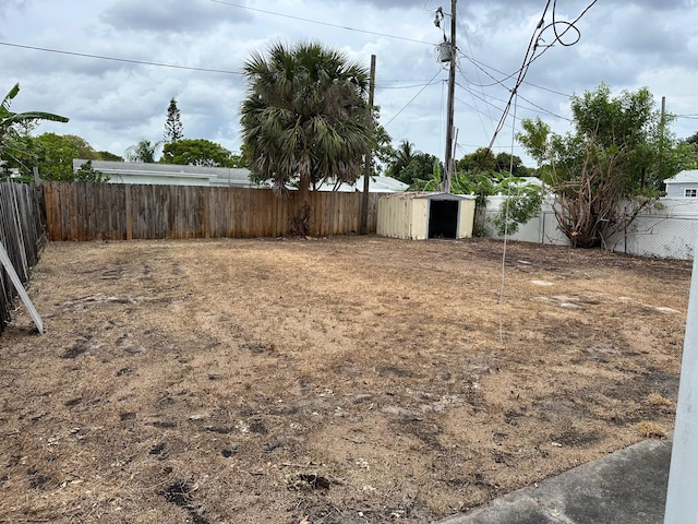 615 Garnett St, Lantana, FL 33462 - fenced backyard with a storage unit and an outbuilding