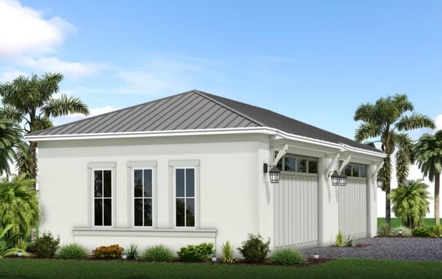 19789 SE Turnbridge Dr Unit Monticello 80, Jupiter, FL 33458 - view of home's exterior featuring a standing seam roof, stucco siding, and metal roof