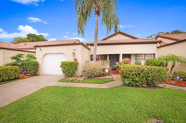 mediterranean / spanish-style home with an attached garage, concrete driveway, a tiled roof, and a front lawn