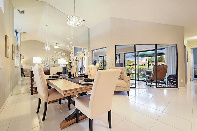 dining space with a chandelier, high vaulted ceiling, light tile patterned floors, and baseboards