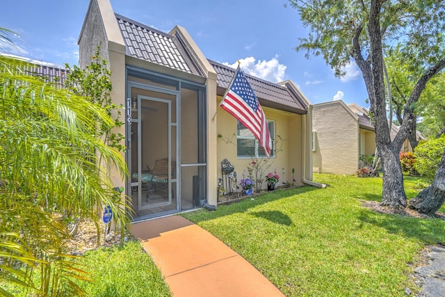 view of front facade with stucco siding and a front lawn