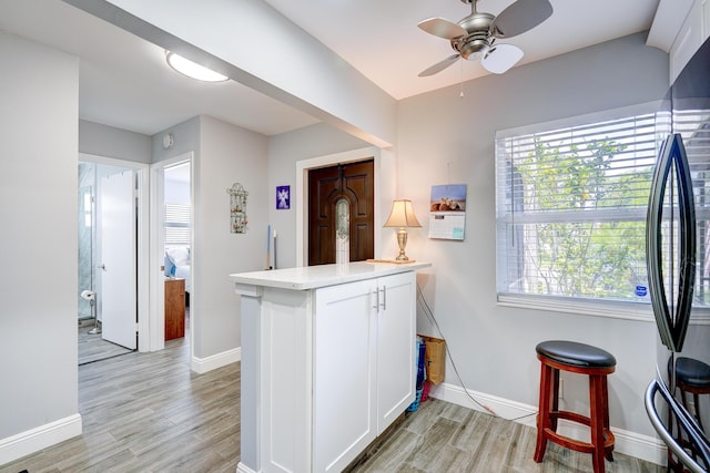 kitchen featuring baseboards and light wood-type flooring