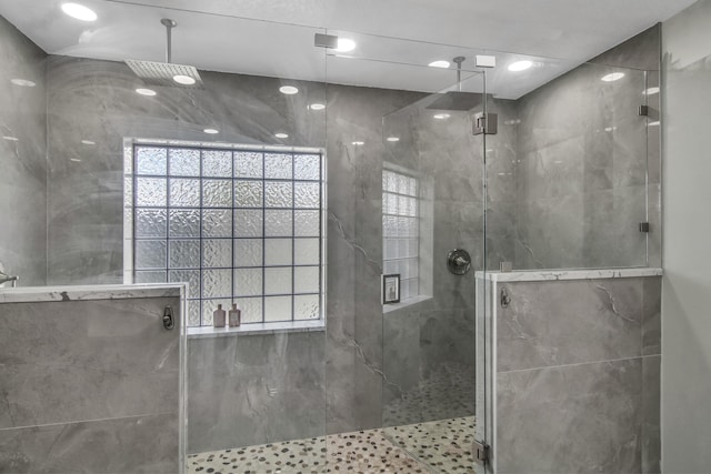 full bathroom with a marble finish shower