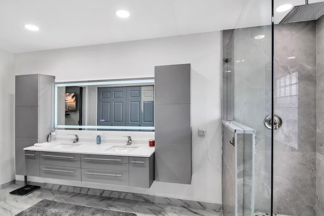 bathroom featuring a sink, a stall shower, and marble finish floor