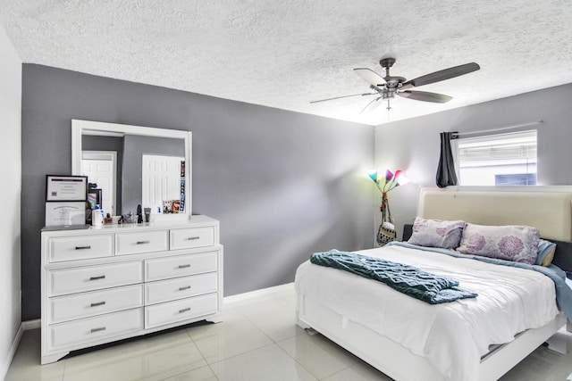 bedroom with baseboards, ceiling fan, and a textured ceiling